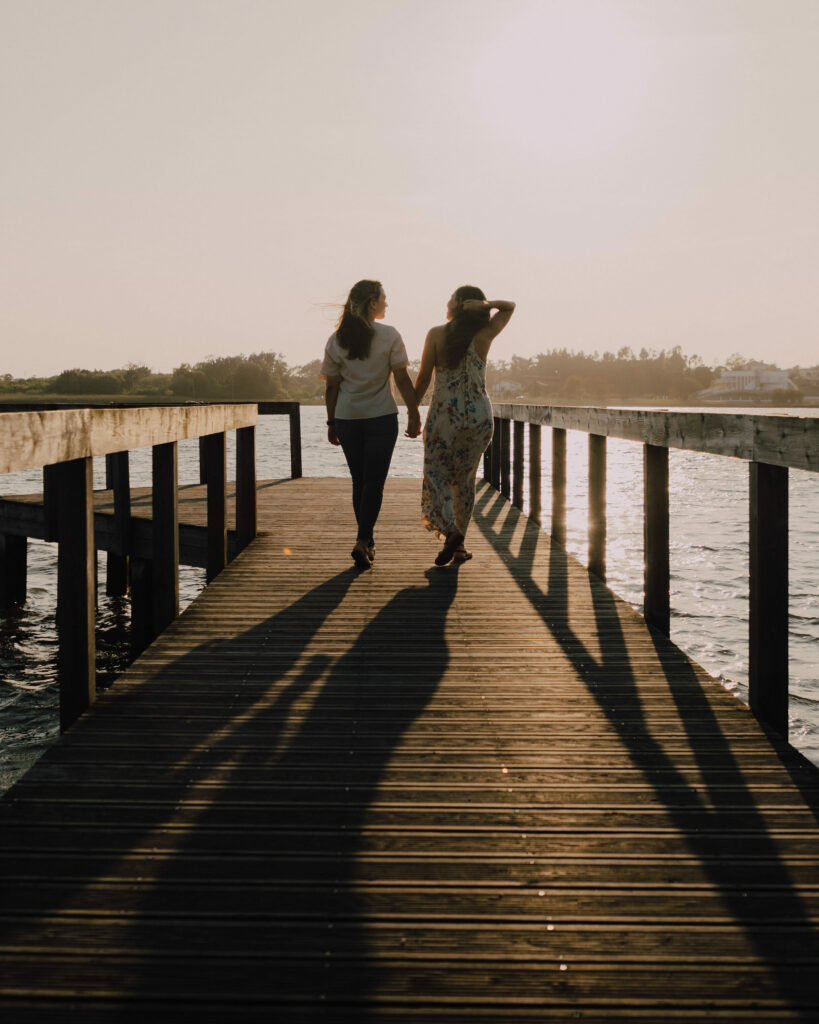 Mariana and Beatriz walking on a pier